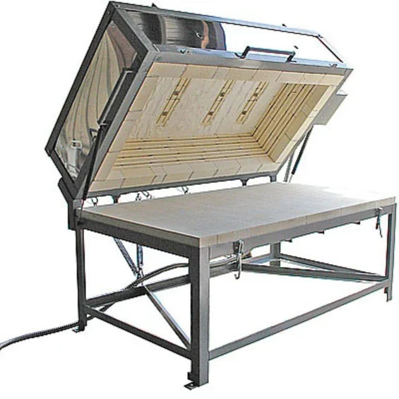 Glass fusing kiln with the lid open showing lid-mounted heating elements above the shelf
