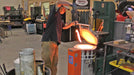 A finished blade being lifted out of a Jen-Ken Vertical Air Bath knife kiln